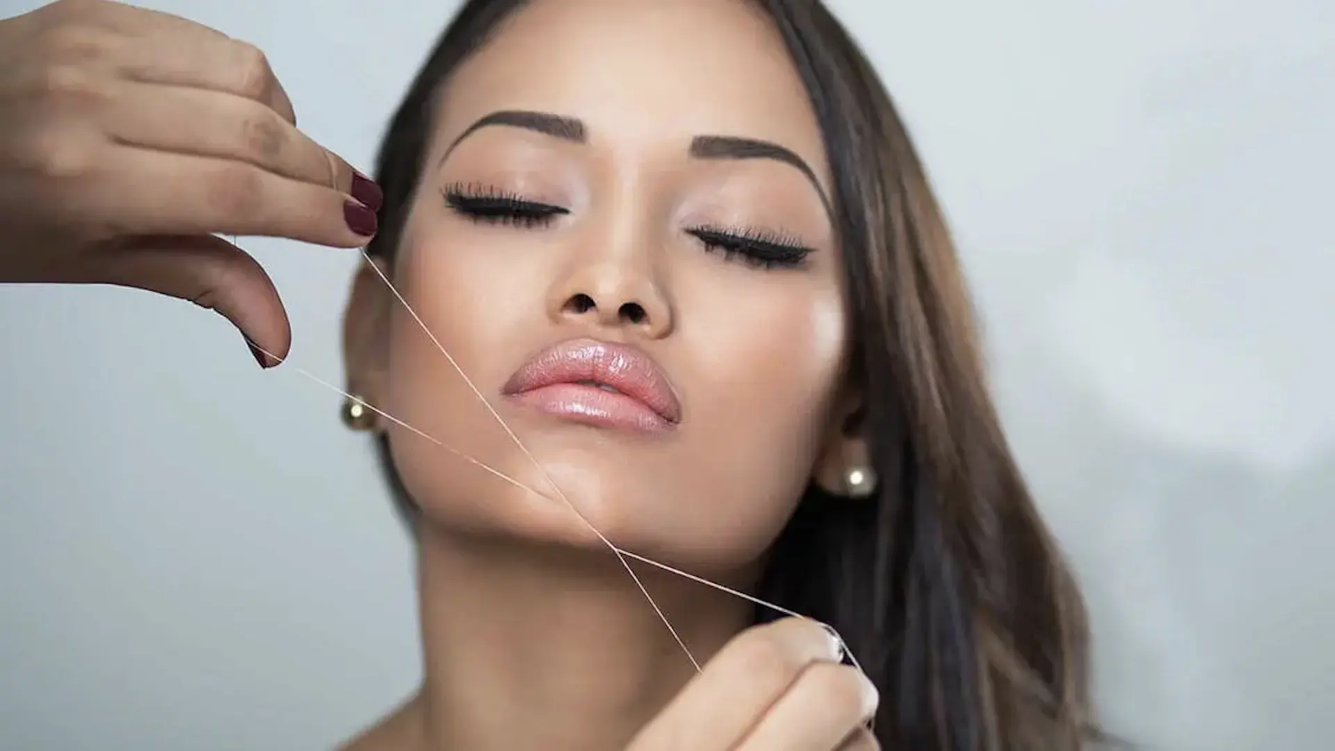customer receiving a chin threading treatment 